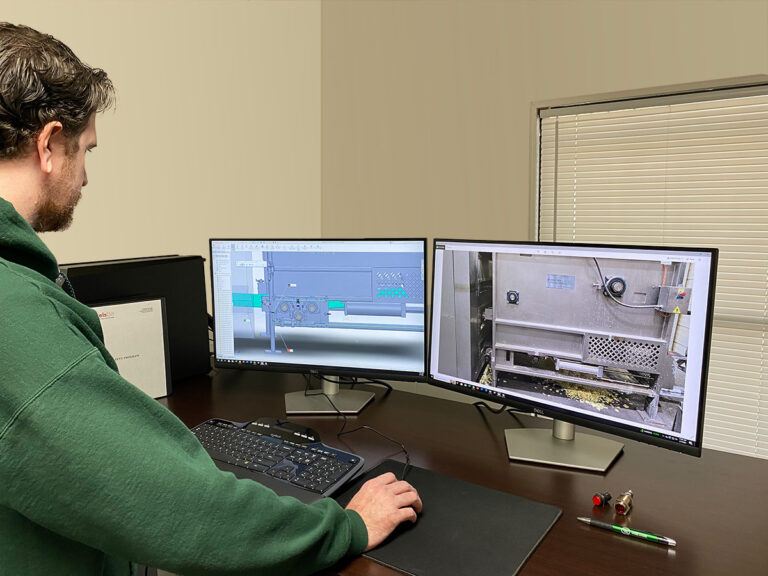 An Eckels Bilt engineer viewing CAD drawings on a dual monitor desktop